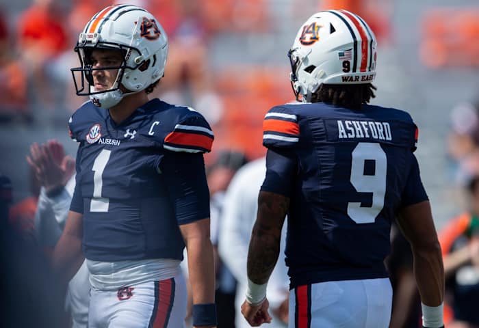 Auburn quarterbacks Patyton Thorne (No. 1) and Robby Ashford (No. 9) warm up during pregame prior to their Week 5 matchup against No. 1 Georgia at Jordan-Hare Stadium.